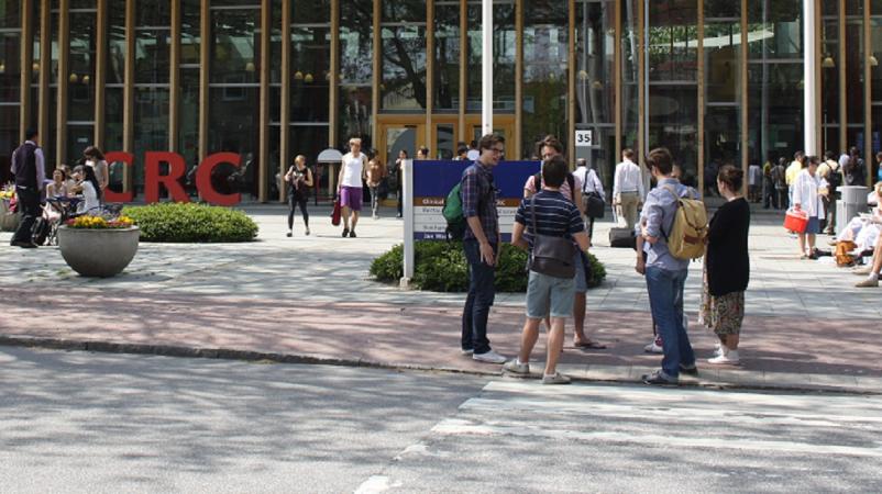 Courtyard with people in front of the Skane building